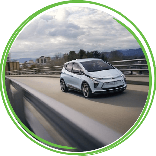 Chevy Bolt EV and EUV parked in front of a modern urban building.